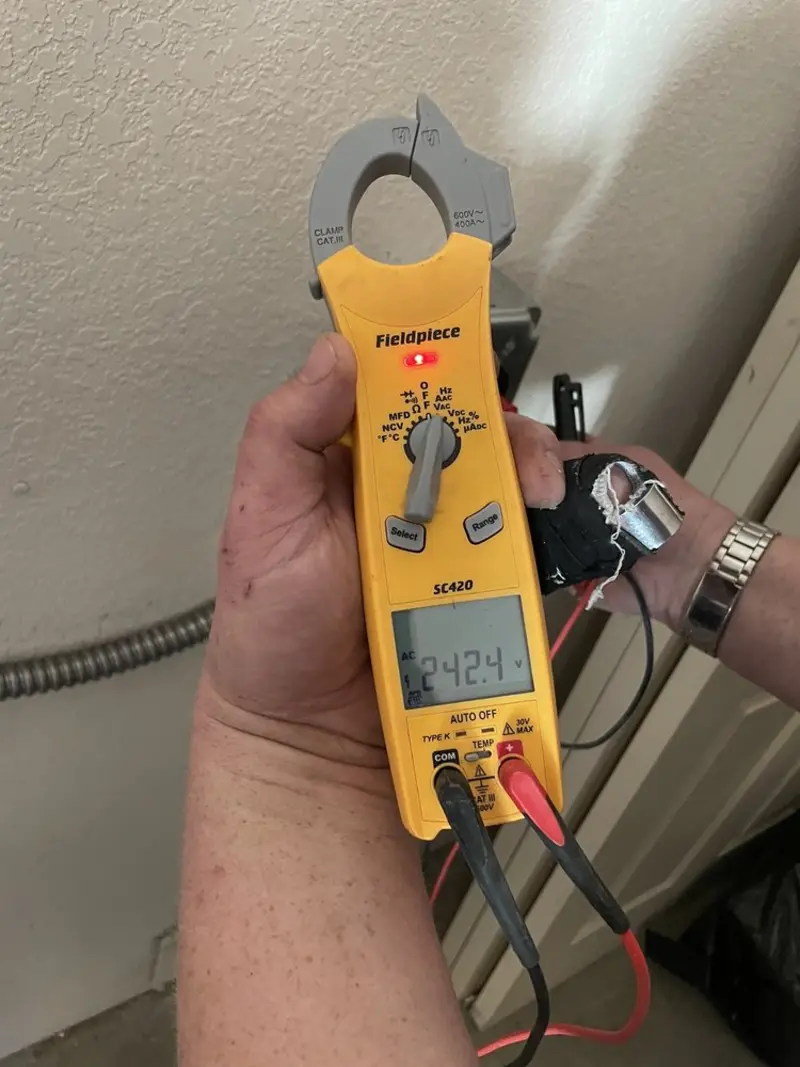 Voltage testing with clamp meter during Ceiling Fan Installation in Valley Falls